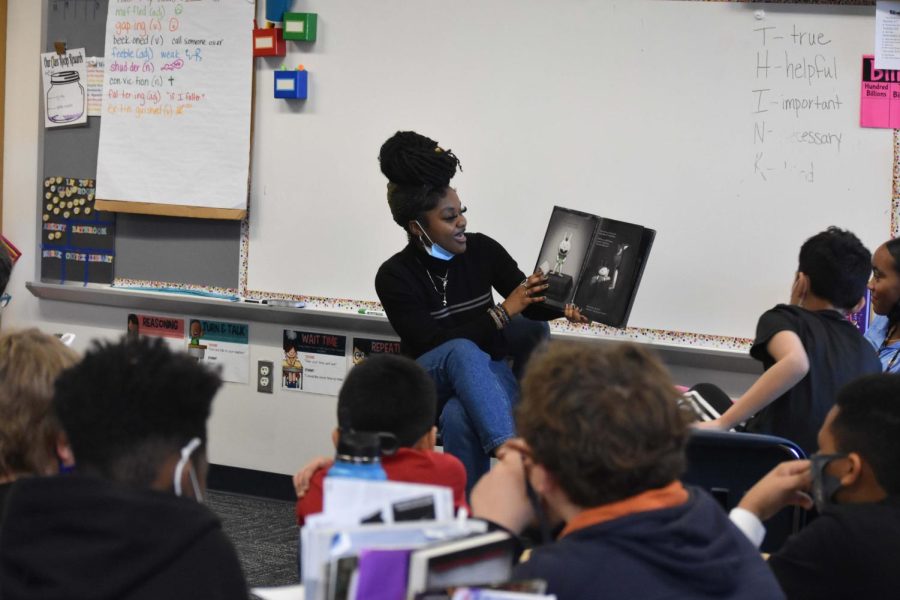 Zamari Holley, a senior at Stafford Senior High School, reads Creepy Pair of Underwear, a children's book by Aaron Reynolds, to students at Conway Elementary on Wednesday, March 2, 2022. 