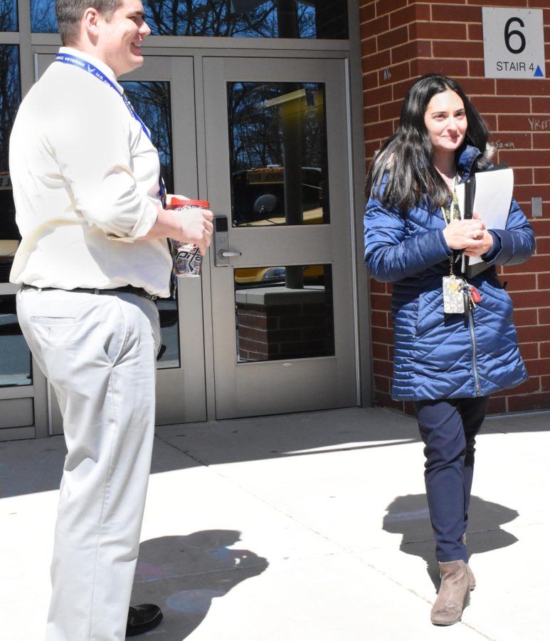 Ms.Baccio stands outside on bus duty.