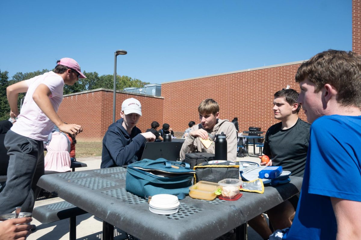Gathered around the lunch table, SHS seniors are enjoying a meal in between classes while surrounded by underclassmen. In the past, the courtyard was for seniors only. This year however, these seniors are not guaranteed spots outside.